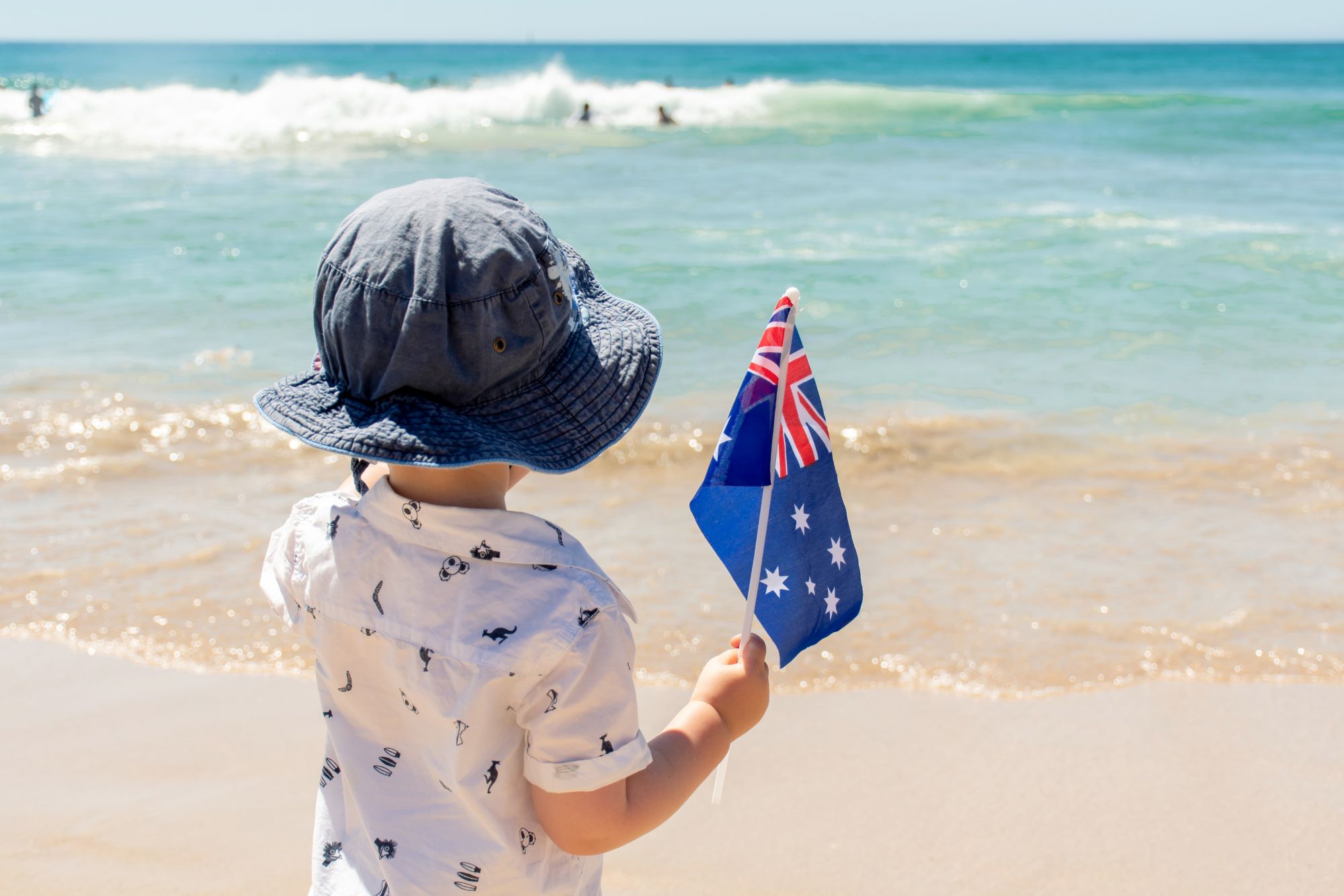 little-boy-with-australian-flag-near-the-ocean-au-2023-11-27-04-59-06-utc