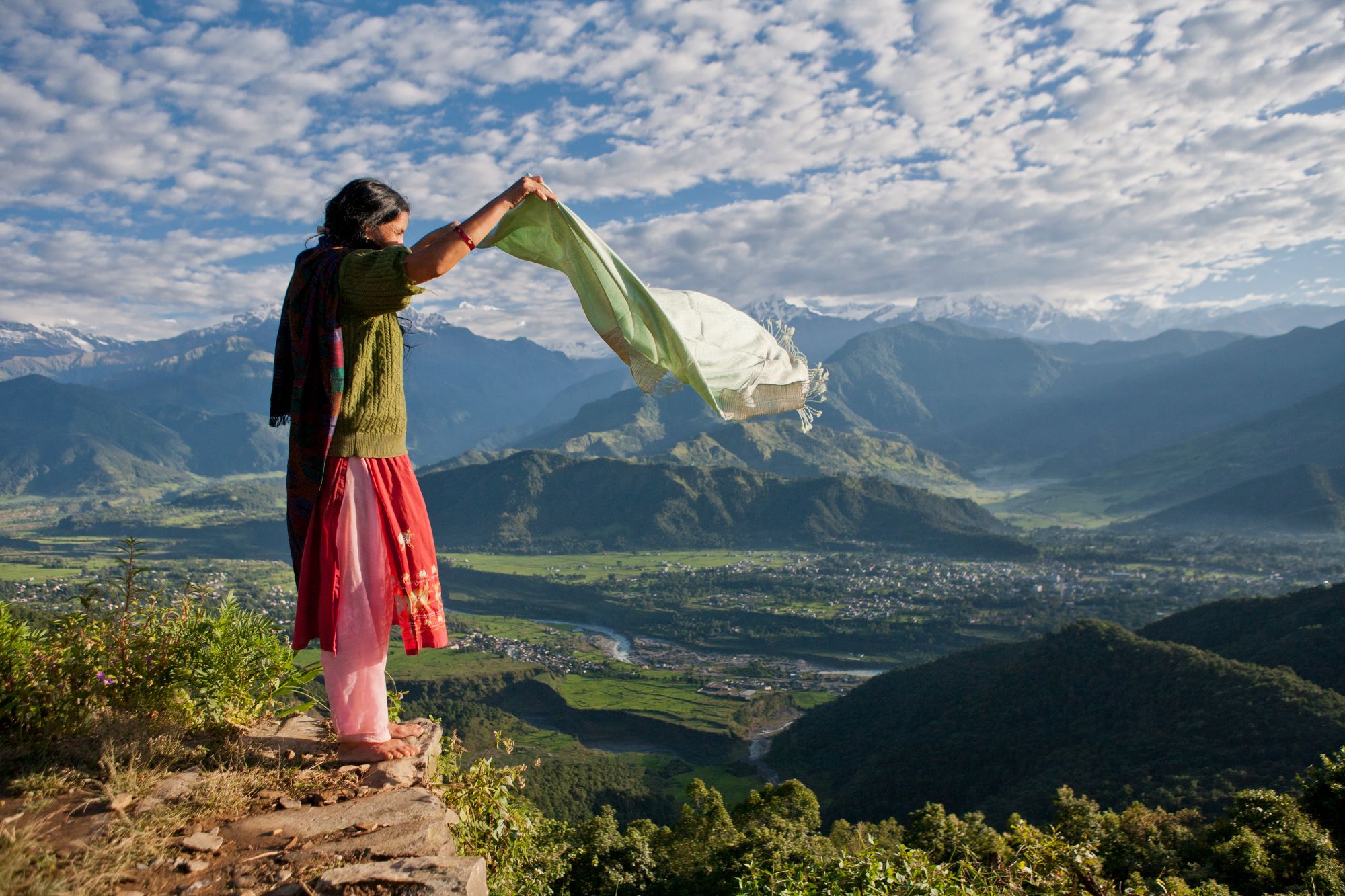 nepalese-woman-holding-scarf-on-cliff-edge-near-po-2023-11-27-05-31-49-utc